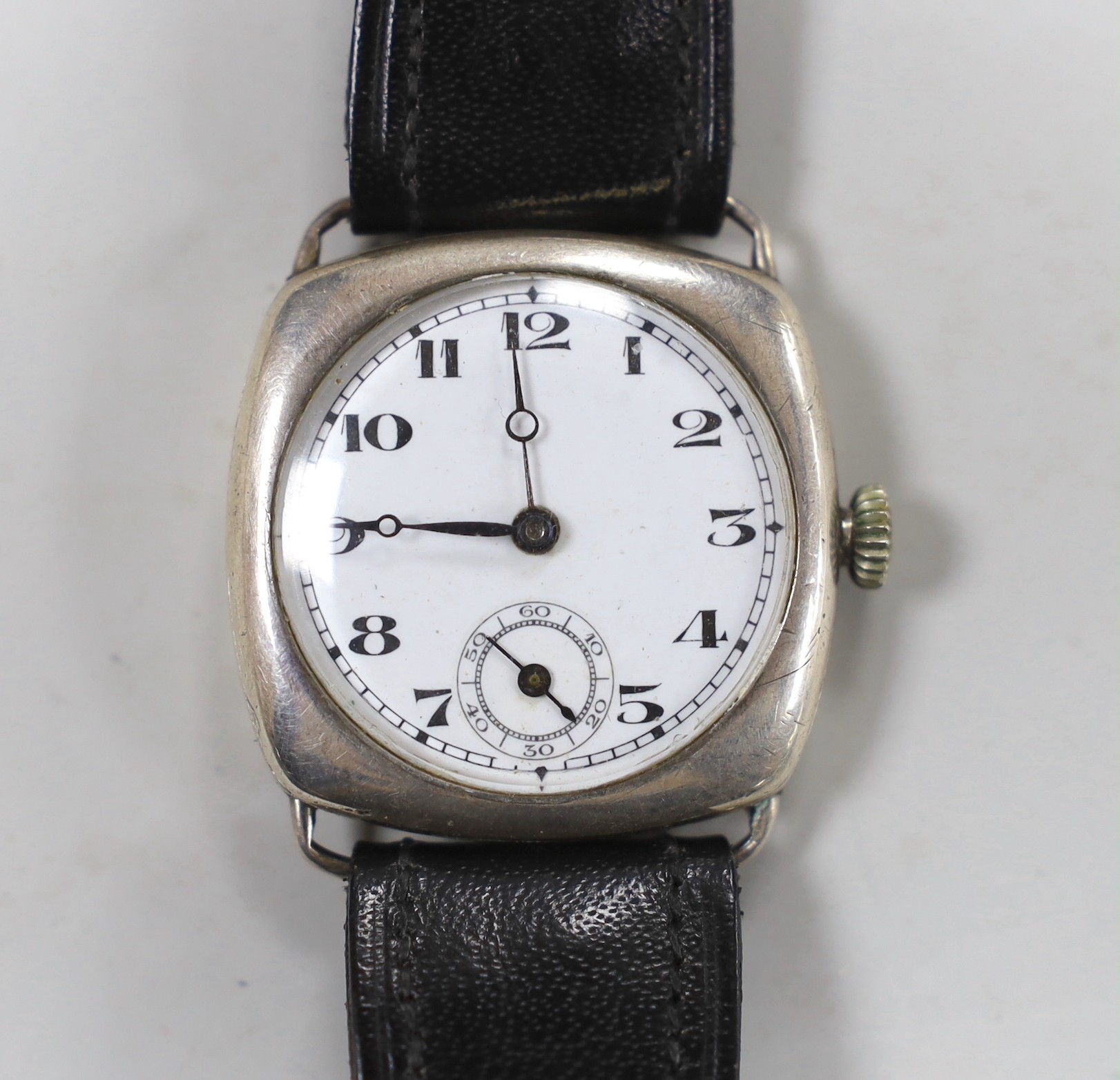 A gentleman's 1920's silver manual wind wrist watch, with Arabic dial and subsidiary seconds, on a later leather strap.